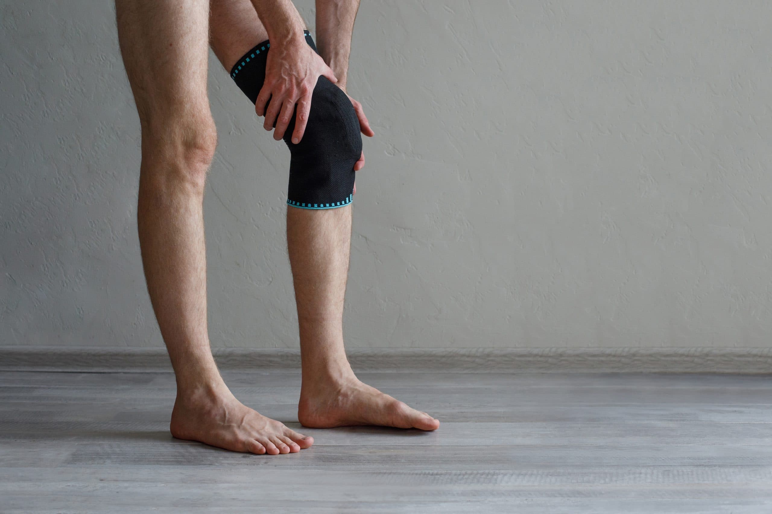 Consultant demonstrating knee implant model in clinic