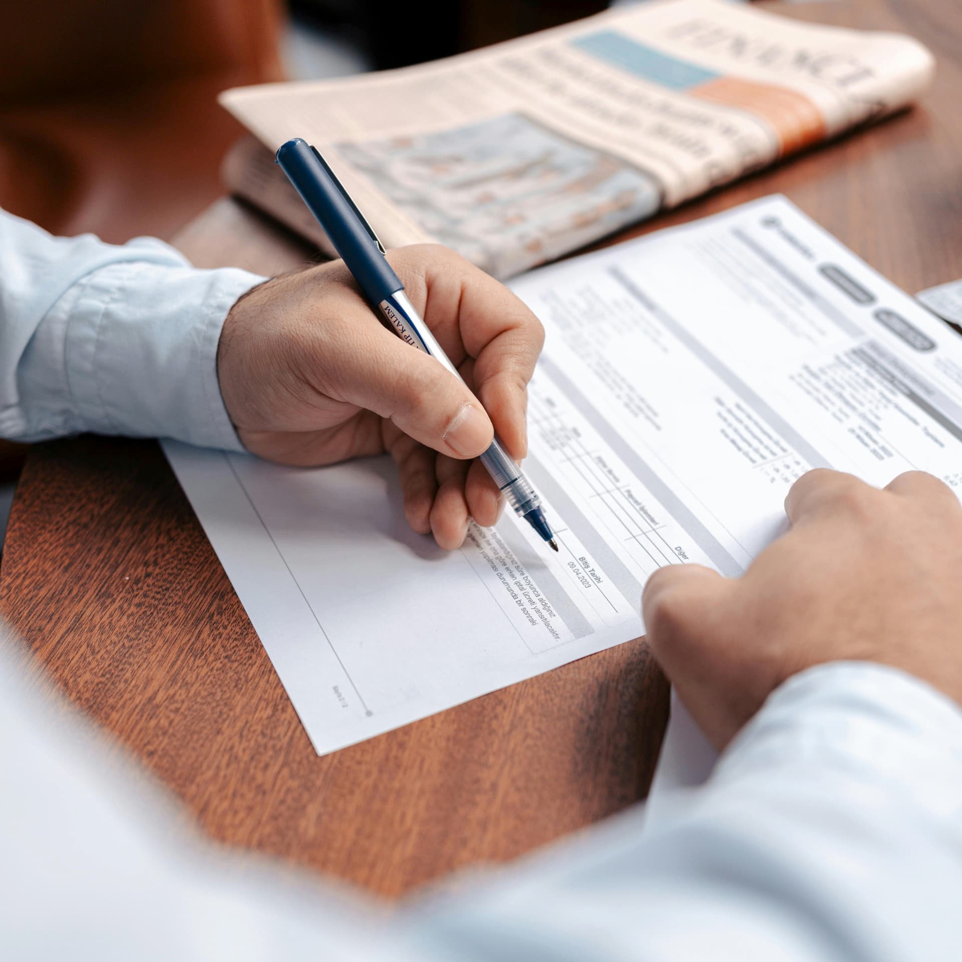 Patient completing paperwork during a self-funded treatment assessment