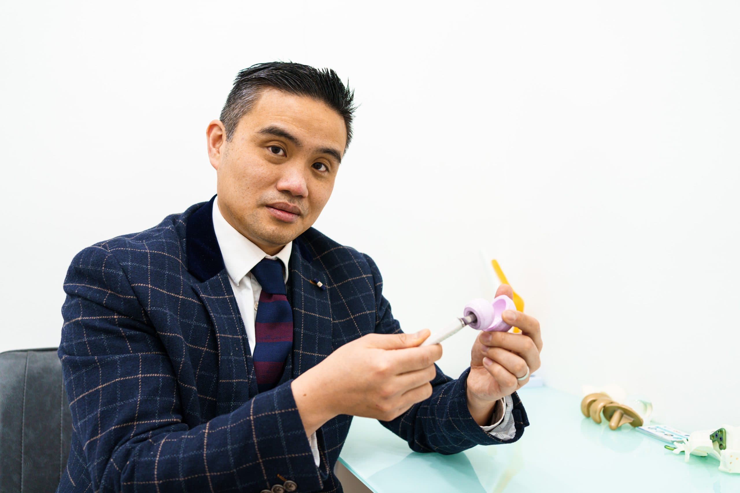 Doctor examining knee in white clinic room
