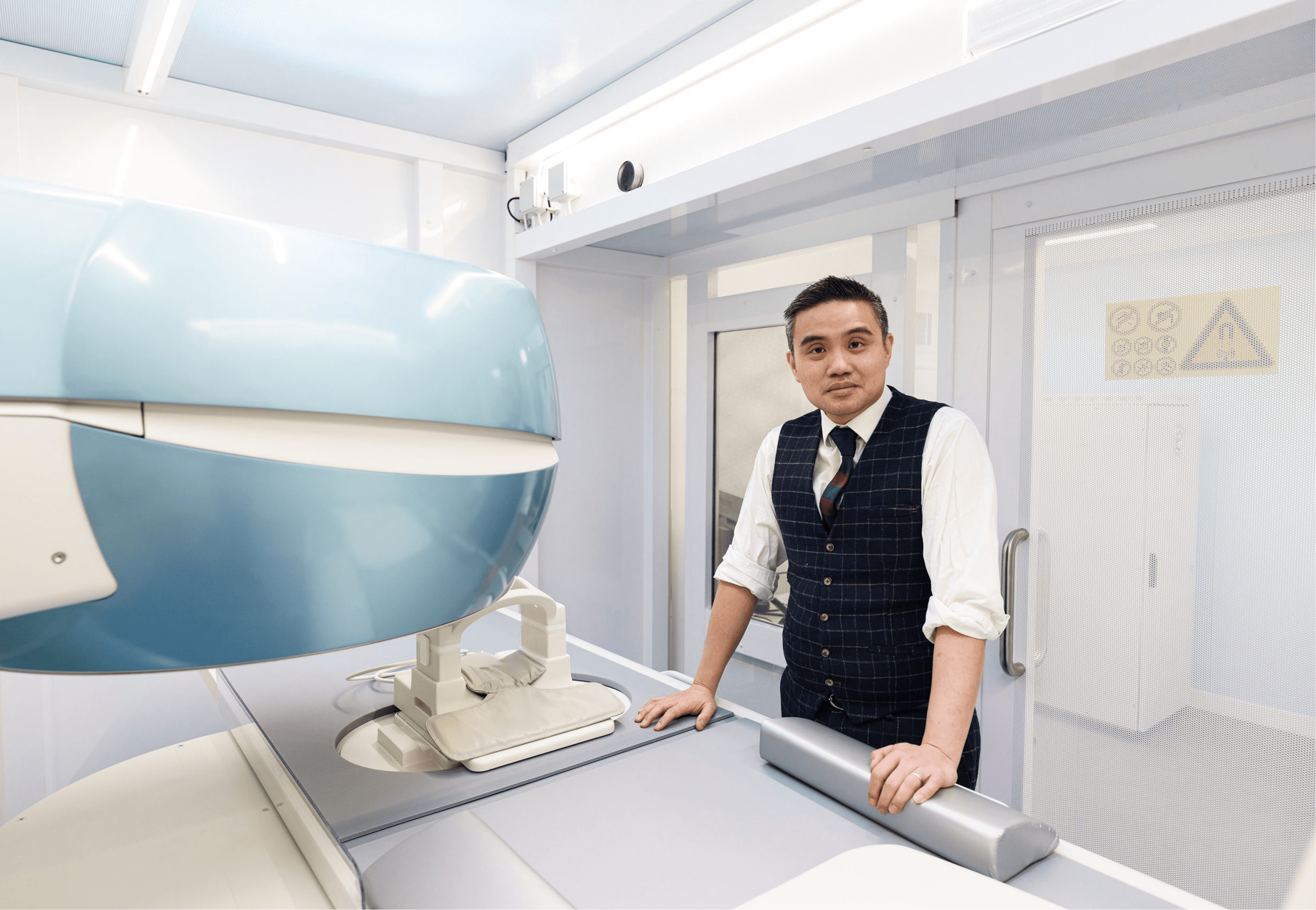 Professor Paul Y.F. Lee reviewing MRI imaging for knee treatment planning