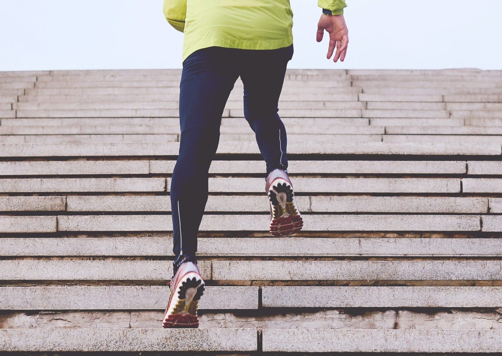 Blue-gloved hands preparing injection syringe