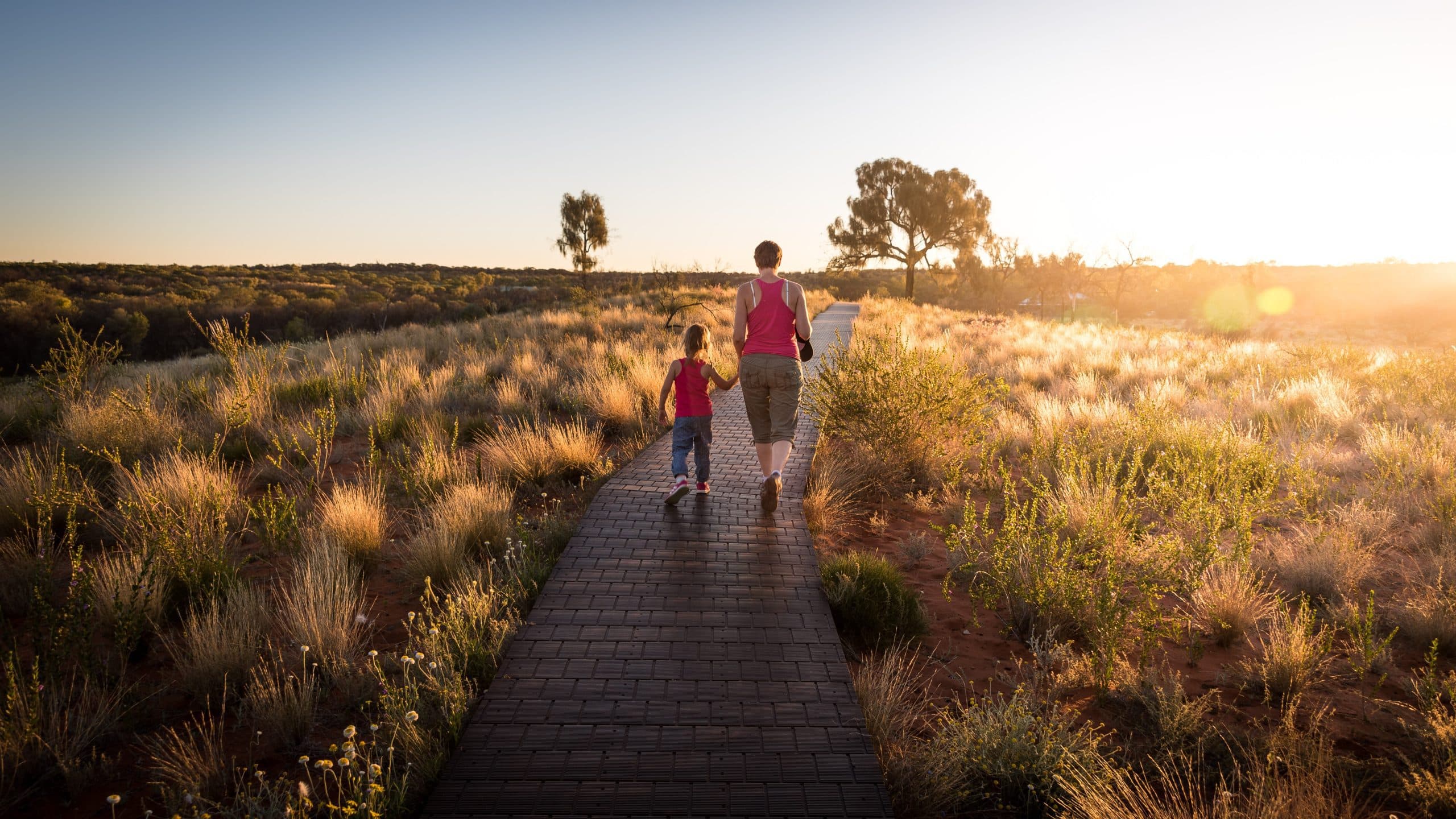 Mother and child walking at sunset, reflecting mobility goals after cartilage repair